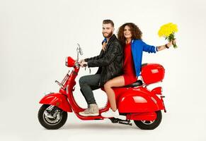 young attractive couple riding an electric motorbike scooter happy having fun together photo