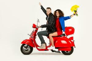 young attractive couple riding an electric motorbike scooter happy having fun together photo