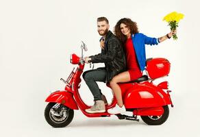 young attractive couple riding an electric motorbike scooter happy having fun together photo