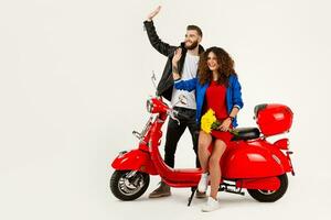 young attractive couple riding an electric motorbike scooter happy having fun together photo