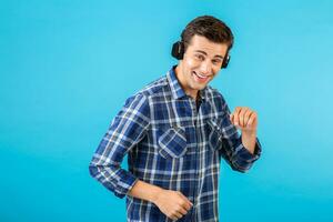 stylish young man listening to music on wireless headphones photo