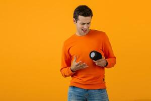 stylish young man holding wireless speaker photo