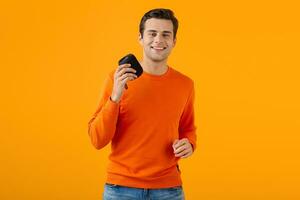 stylish young man holding wireless speaker photo