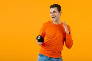 stylish young man holding wireless speaker photo