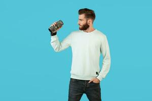 stylish young man holding wireless speaker photo