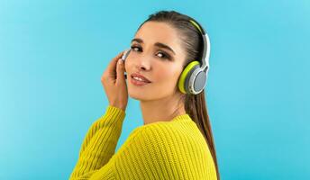 stylish young woman holding listening to music in headphones photo