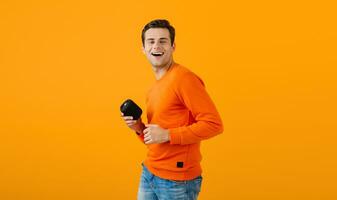 stylish young man holding wireless speaker photo