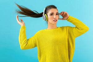 stylish young woman holding listening to music in headphones photo