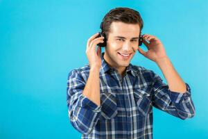 stylish young man listening to music on wireless headphones photo