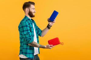 stylish young man holding wireless speakers photo