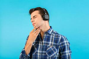 stylish young man listening to music on wireless headphones photo