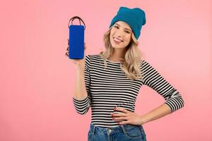 young woman holding music speaker photo