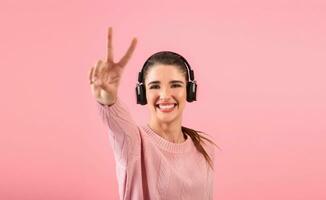 young woman listening to music in headphones photo