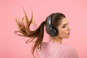 young woman listening to music in headphones photo