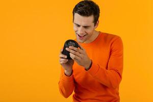 stylish young man holding wireless speaker photo