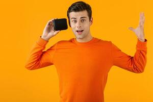 stylish young man holding wireless speaker photo