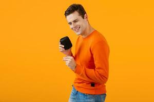 stylish young man holding wireless speaker photo