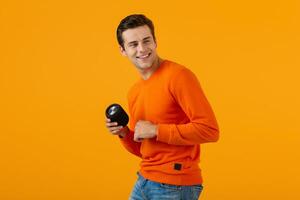 stylish young man holding wireless speaker photo