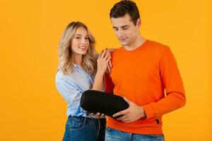 attractive stylish young couple holding wireless speaker photo
