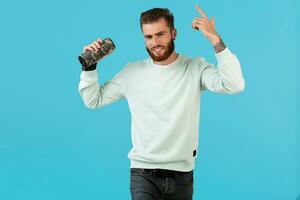 stylish young man holding wireless speaker photo