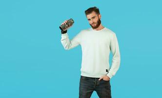 stylish young man holding wireless speaker photo