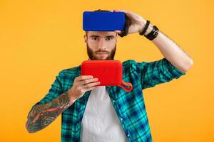 stylish young man holding wireless speakers photo