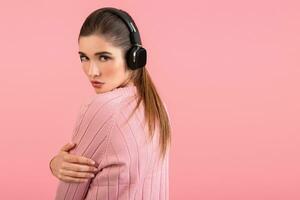young woman listening to music in headphones photo