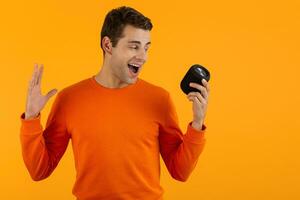 stylish young man holding wireless speaker photo