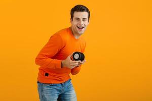 stylish young man holding wireless speaker photo