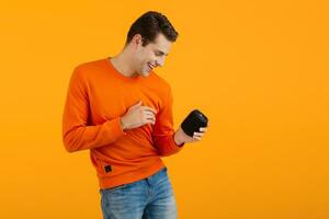 stylish young man holding wireless speaker photo