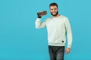 stylish young man holding wireless speaker photo