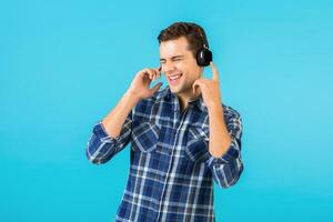 stylish young man listening to music on wireless headphones photo