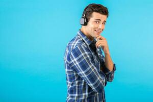 stylish young man listening to music on wireless headphones photo