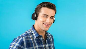 stylish young man listening to music on wireless headphones photo