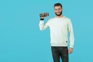 stylish young man holding wireless speaker photo