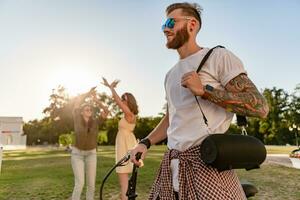 company of friends having fun together in park listening to music photo