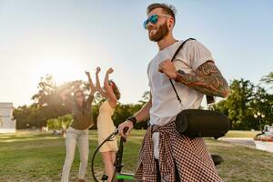 company of friends having fun together in park listening to music photo