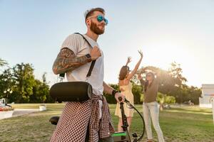 company of friends having fun together in park listening to music photo