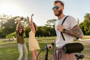 company of friends having fun together in park listening to music photo