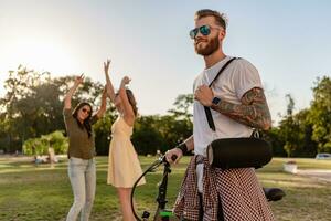 company of friends having fun together in park listening to music photo