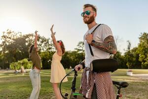 company of friends having fun together in park listening to music photo