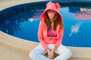 attractive woman in colorful pink hoodie photo