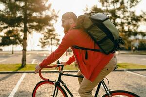 handsome bearded man traveling with bicycle in morning photo