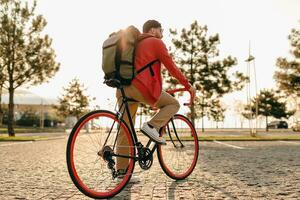 handsome bearded man traveling with bicycle in morning photo