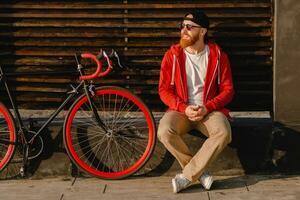 handsome bearded man traveling with bicycle in morning photo