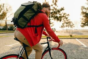 handsome bearded man traveling with bicycle in morning photo