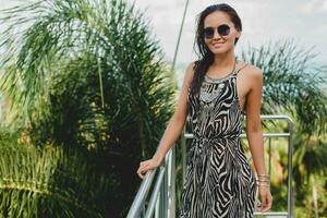 young asian sexy beautiful woman in tropical dress, zebra print photo