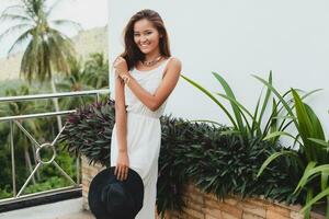 young stylish asian woman in white boho dress photo