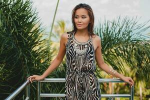 young asian sexy beautiful woman in tropical dress, zebra print photo