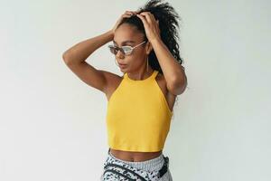 attractive black african american woman posing in stylish hipster outfit on white background photo